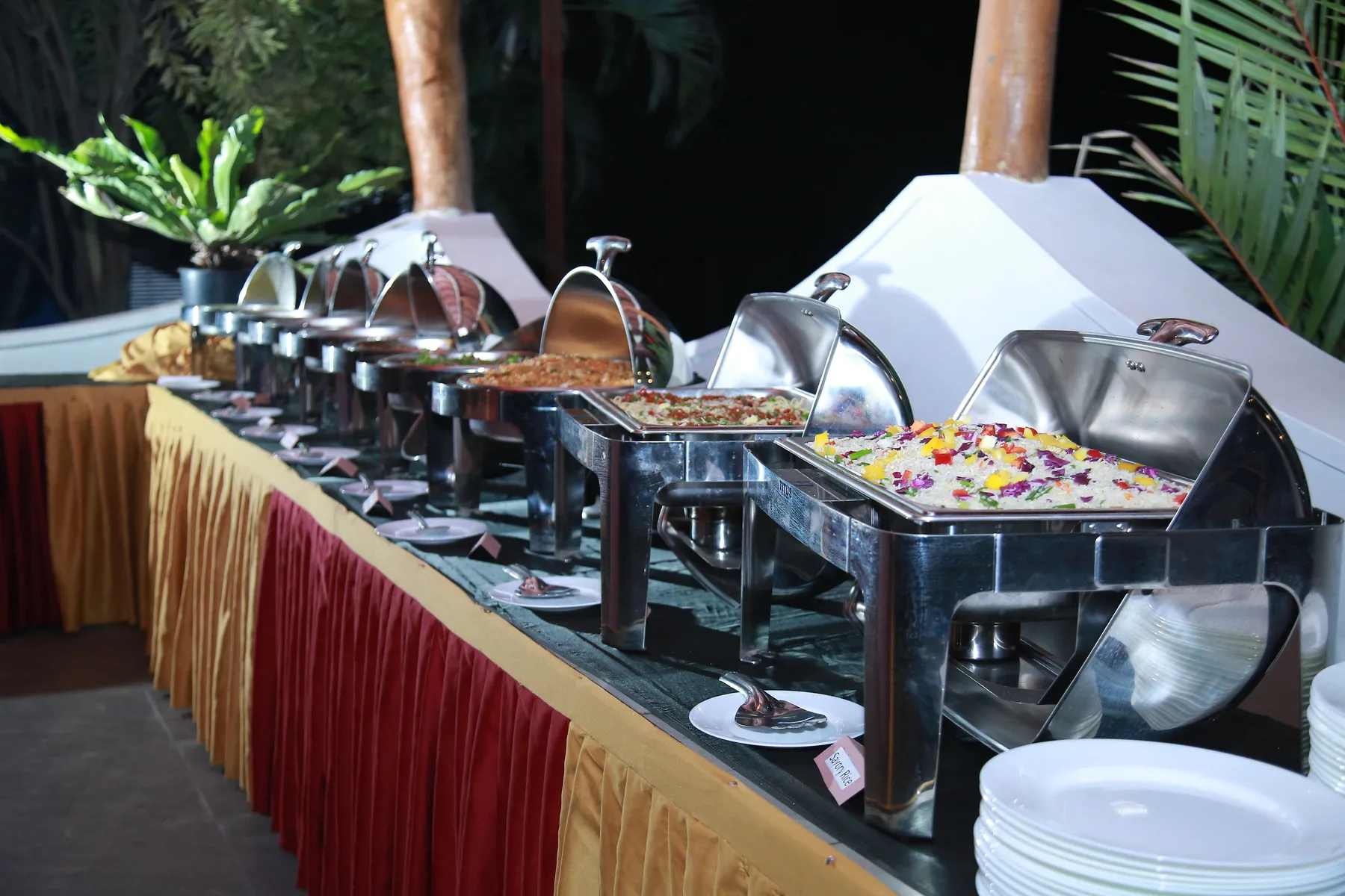 Chef preparing Indian dishes in a professional catering kitchen