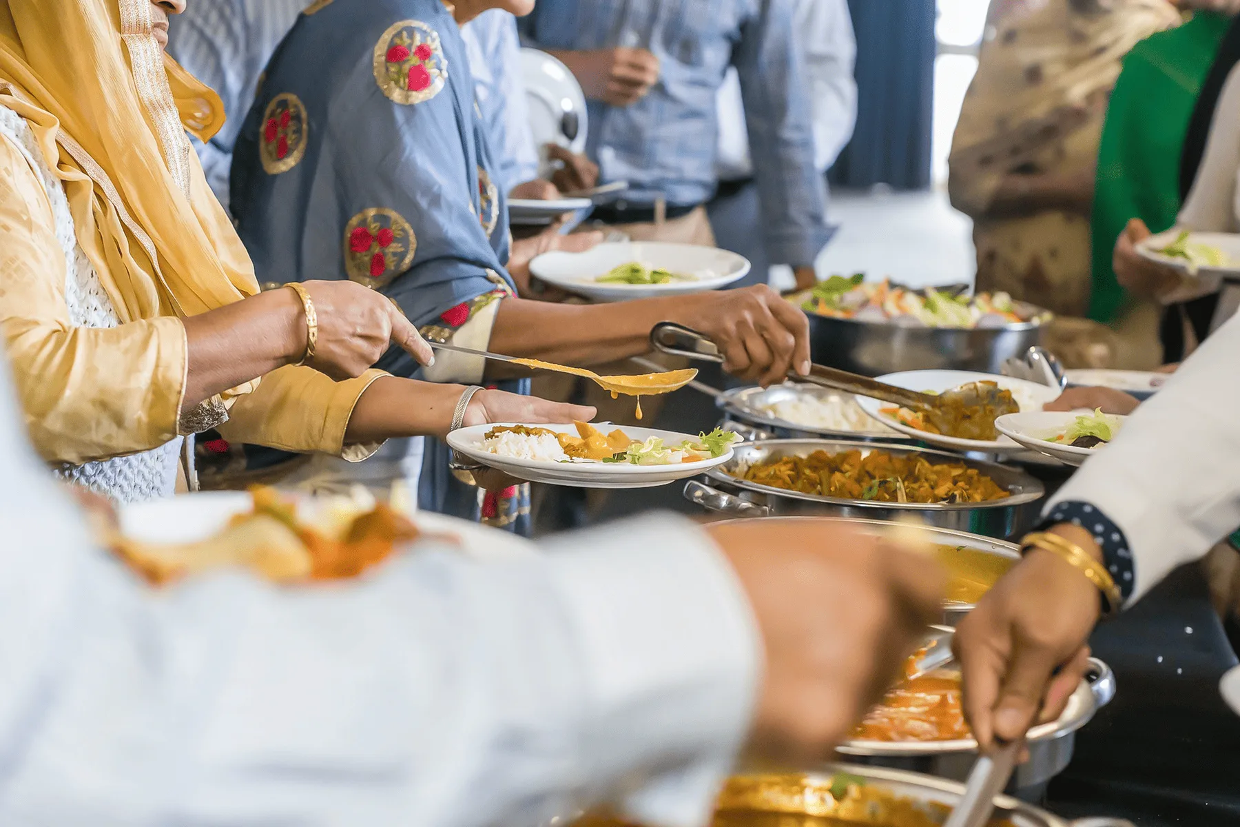 Catering team coordinating on-site food preparation at a destination wedding