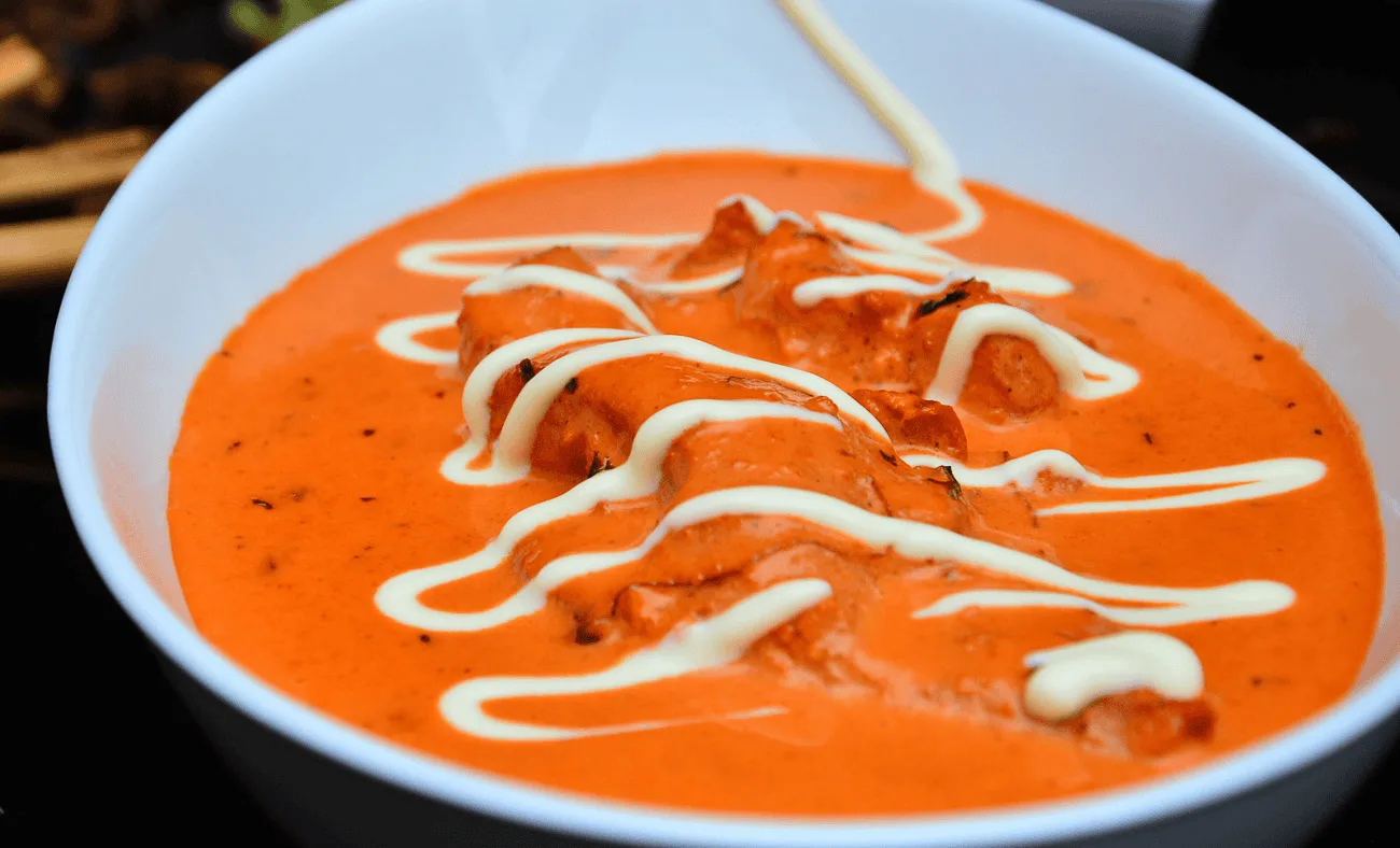 Bowls of turmeric, cumin, coriander and other Indian spices with fresh ingredients