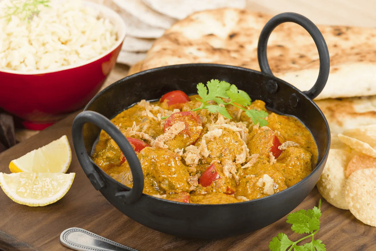 Indian curry served with rice and freshly baked naan bread