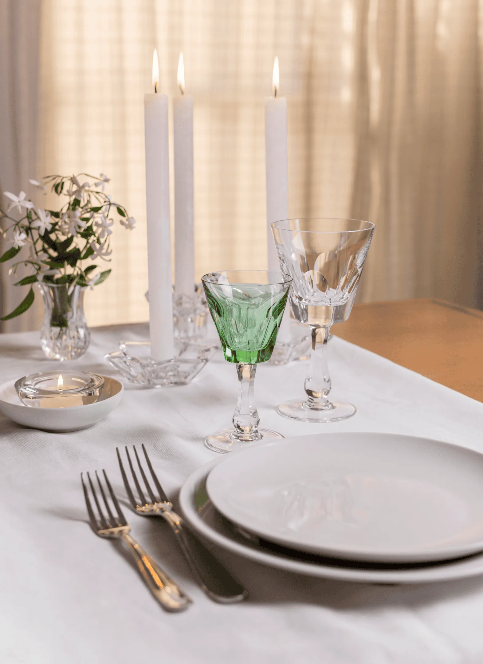 Dinner table set with candles and flowers for a romantic Indian meal at home