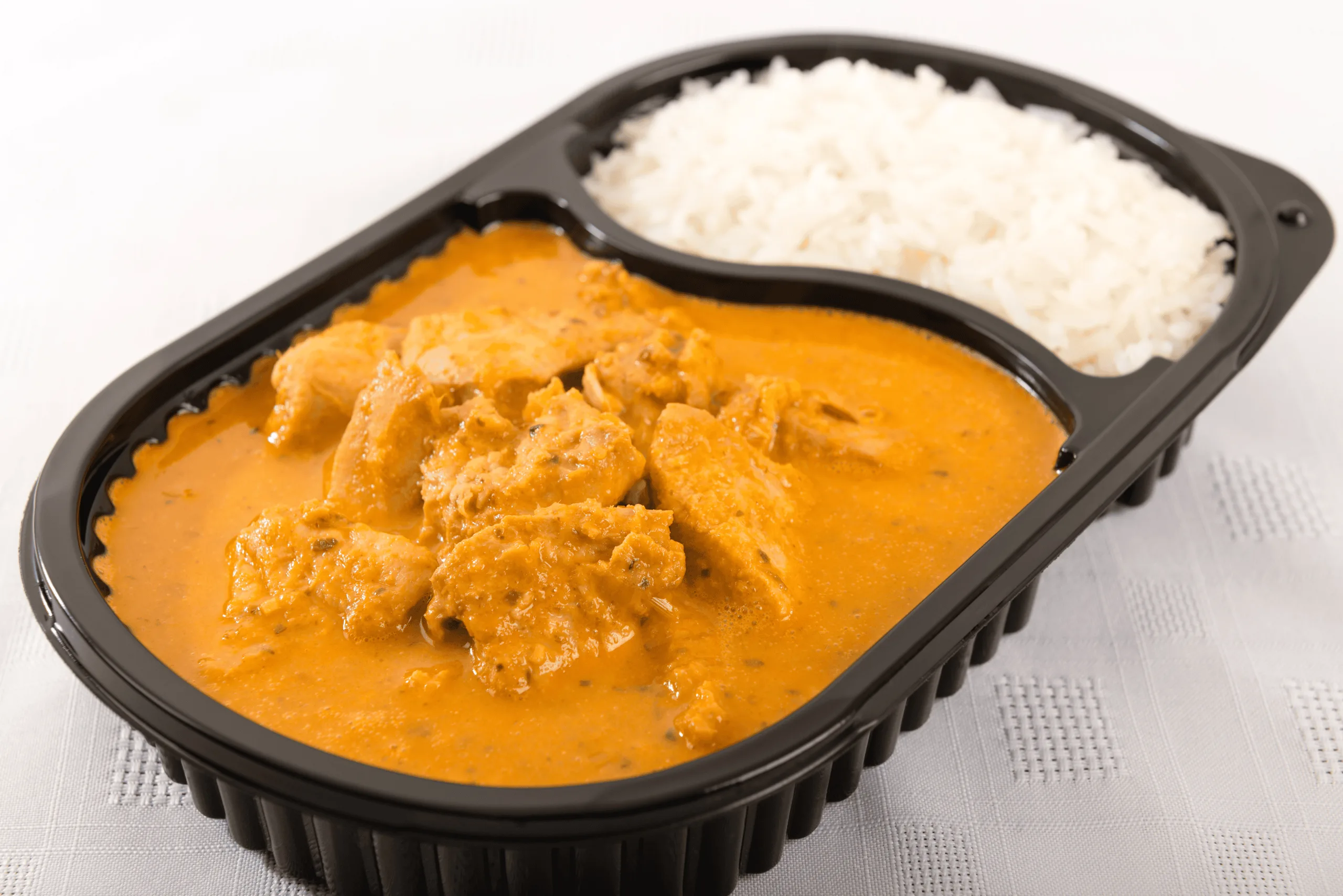 Bowl of butter chicken curry served by candlelight for a romantic dinner