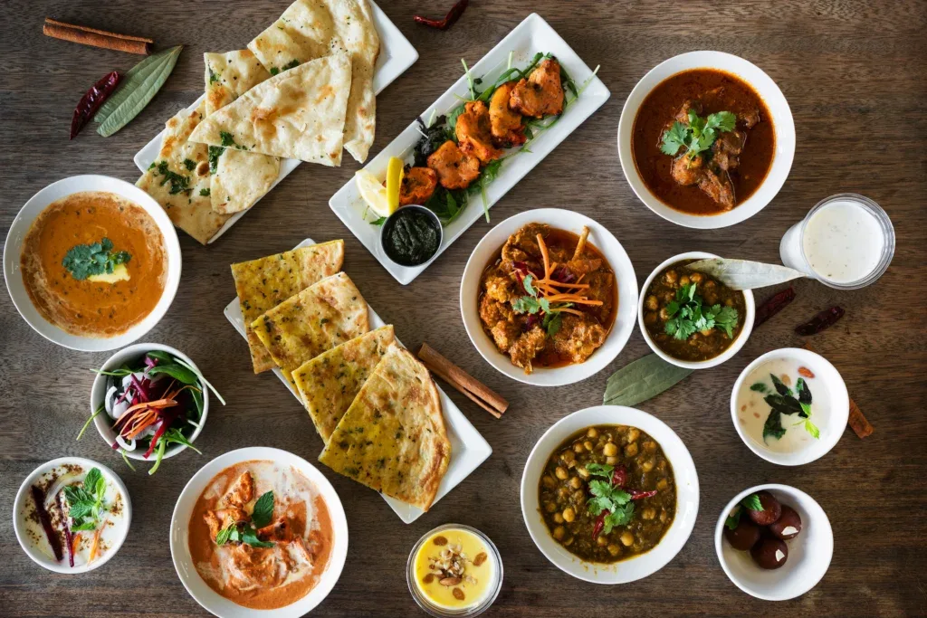 North Indian curries, rice and naan served together on a table