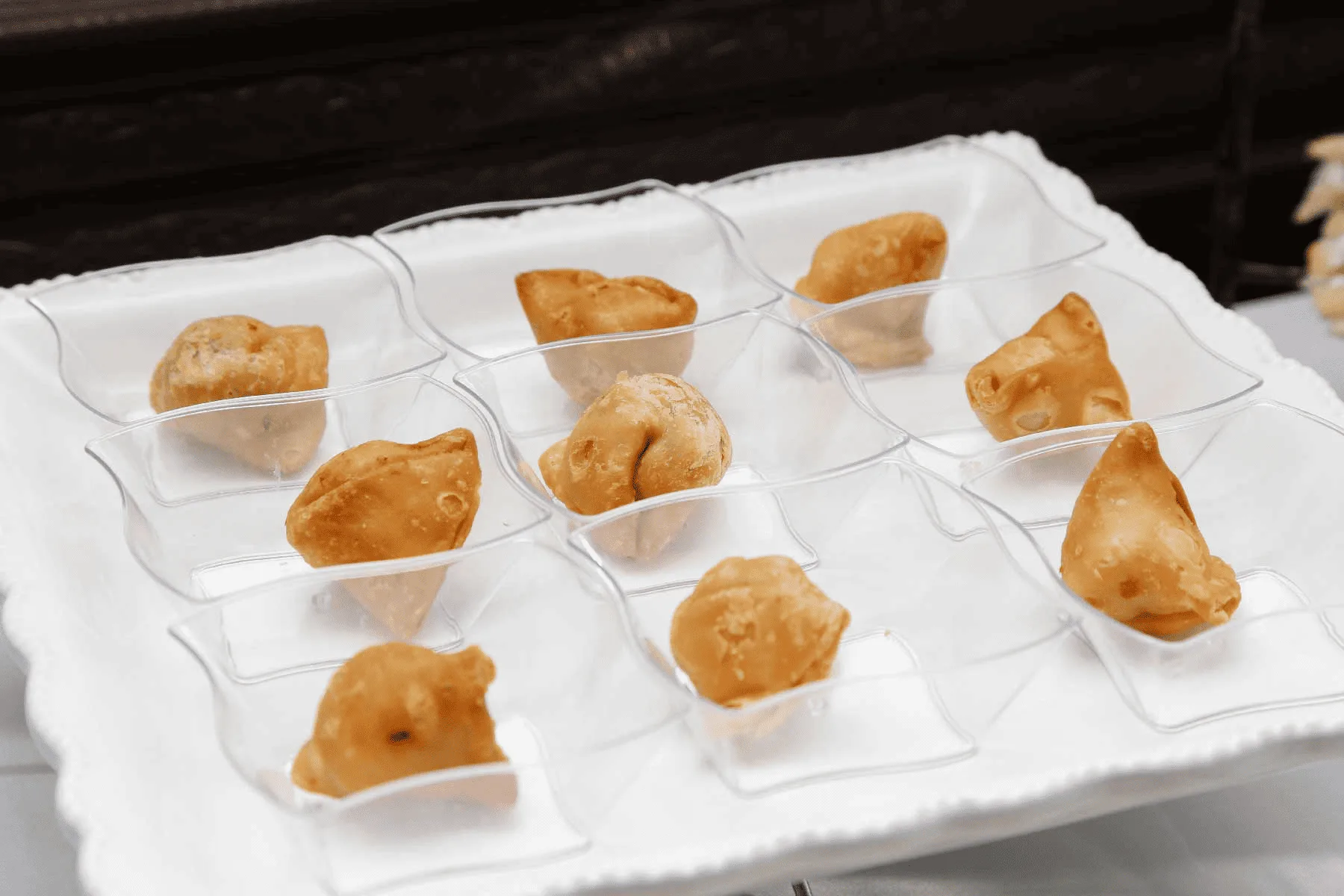 Buffet-style Indian catering service with portioned dishes and a variety of choices