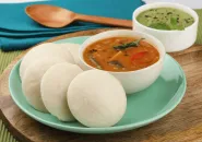 Steamed idli served with sambar and coconut chutney