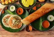 A South Indian dosa served with chutneys and sambar